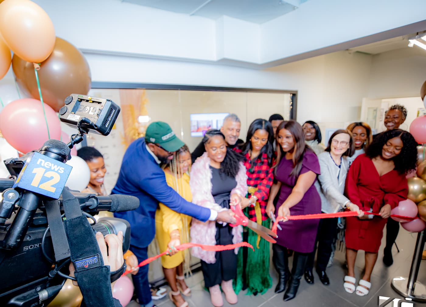 A ribbon cutting in Brooklyn, with local television covering.